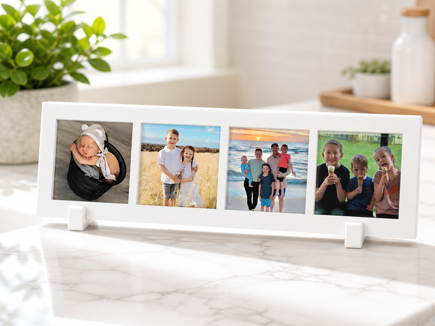 White photo frame with four family photos on a marble surface